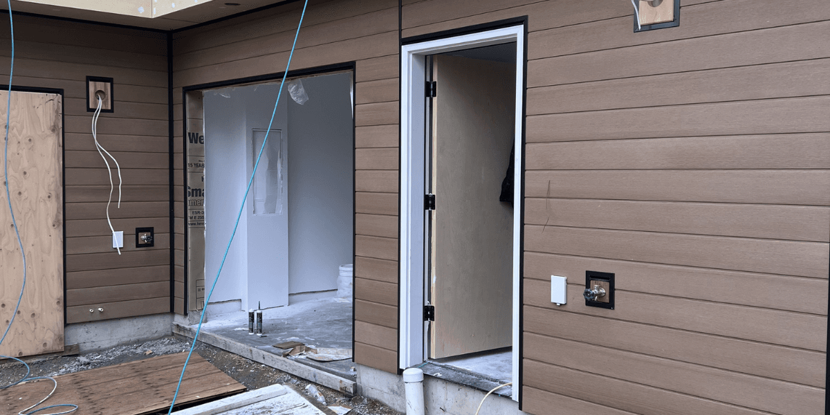 New brown lap siding around an exterior doorway
