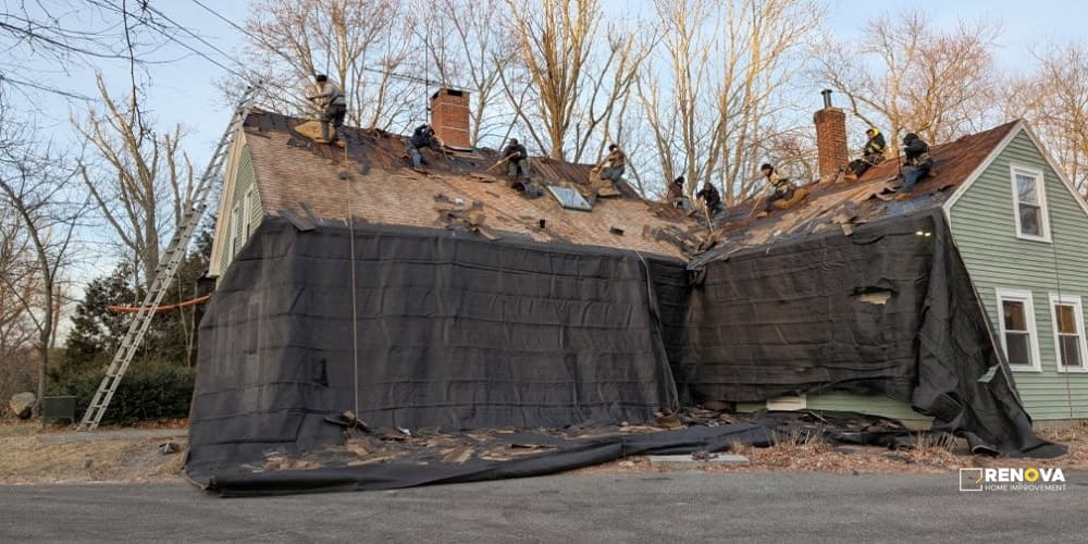 Residential roof stripped to decking and covered for weather protection